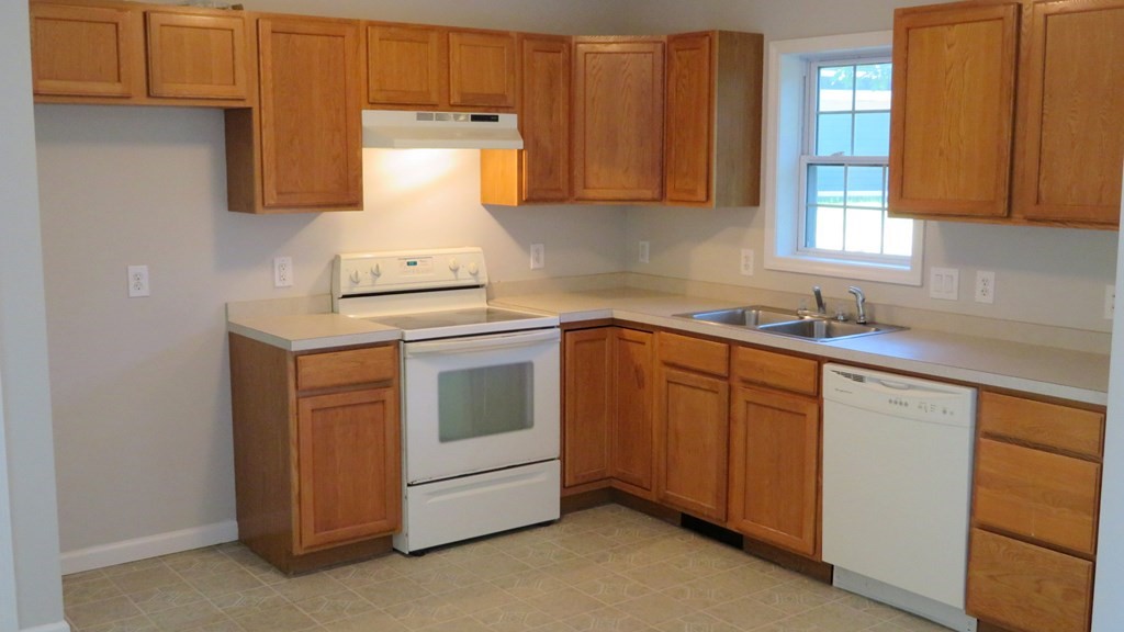 4 Sandy Beach Road Westford, MA 01886 - Photo 10 of 15 a kitchen with sink a stove and cabinets