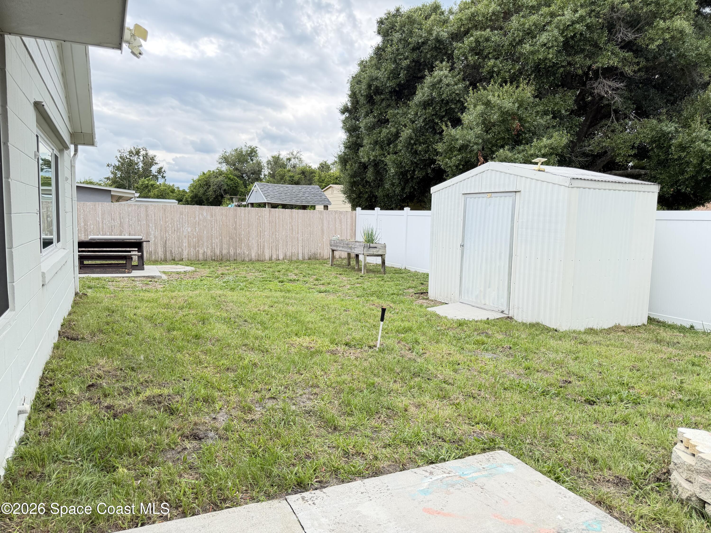 1578 West Powder Horn Road Titusville, FL 32796 - Photo 19 of 22 a backyard of a house with lots of green space