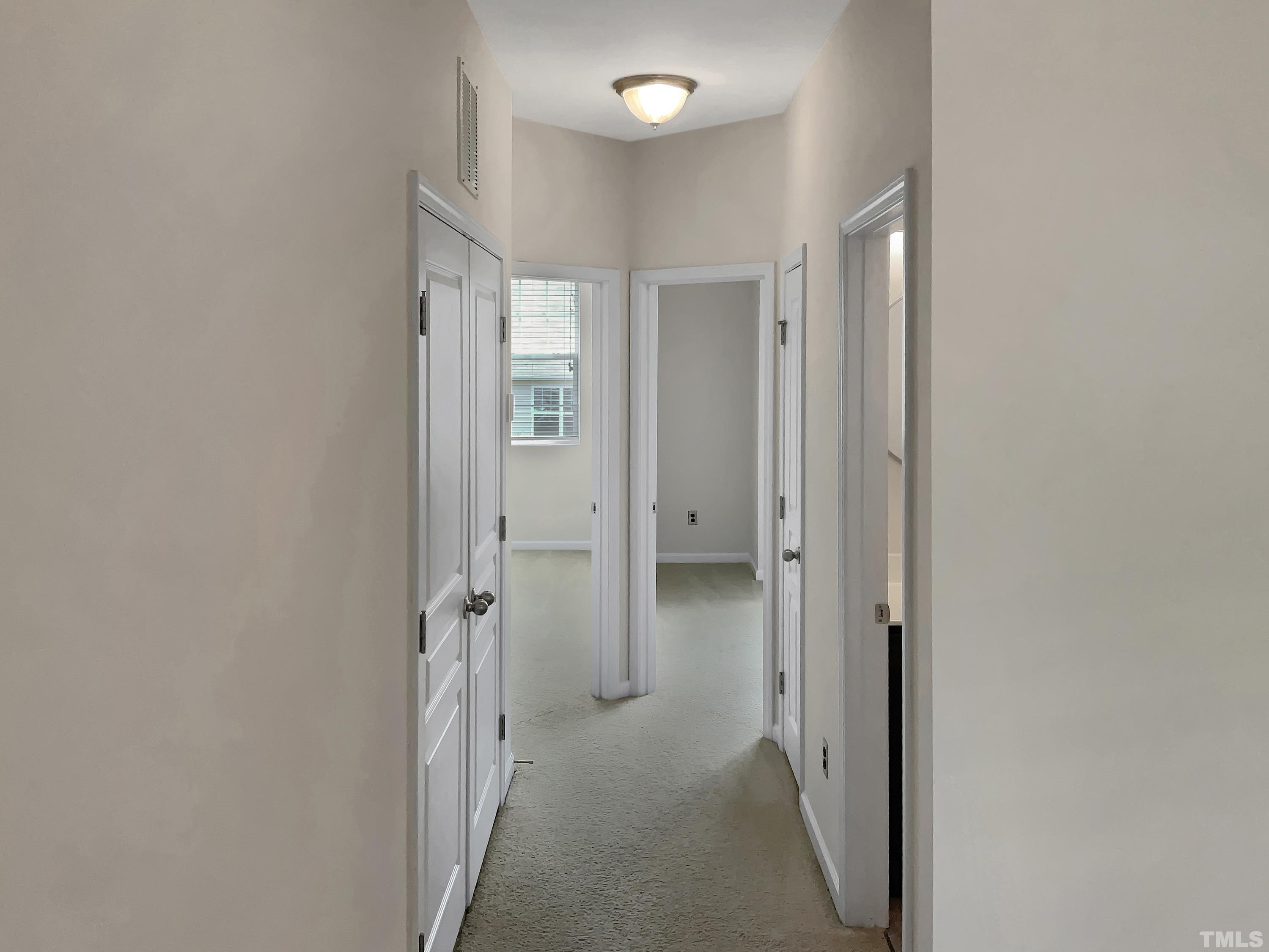 7249 Terregles Drive Raleigh, NC 27617 - Photo 23 of 36 a view of a hallway with closet and wooden floor