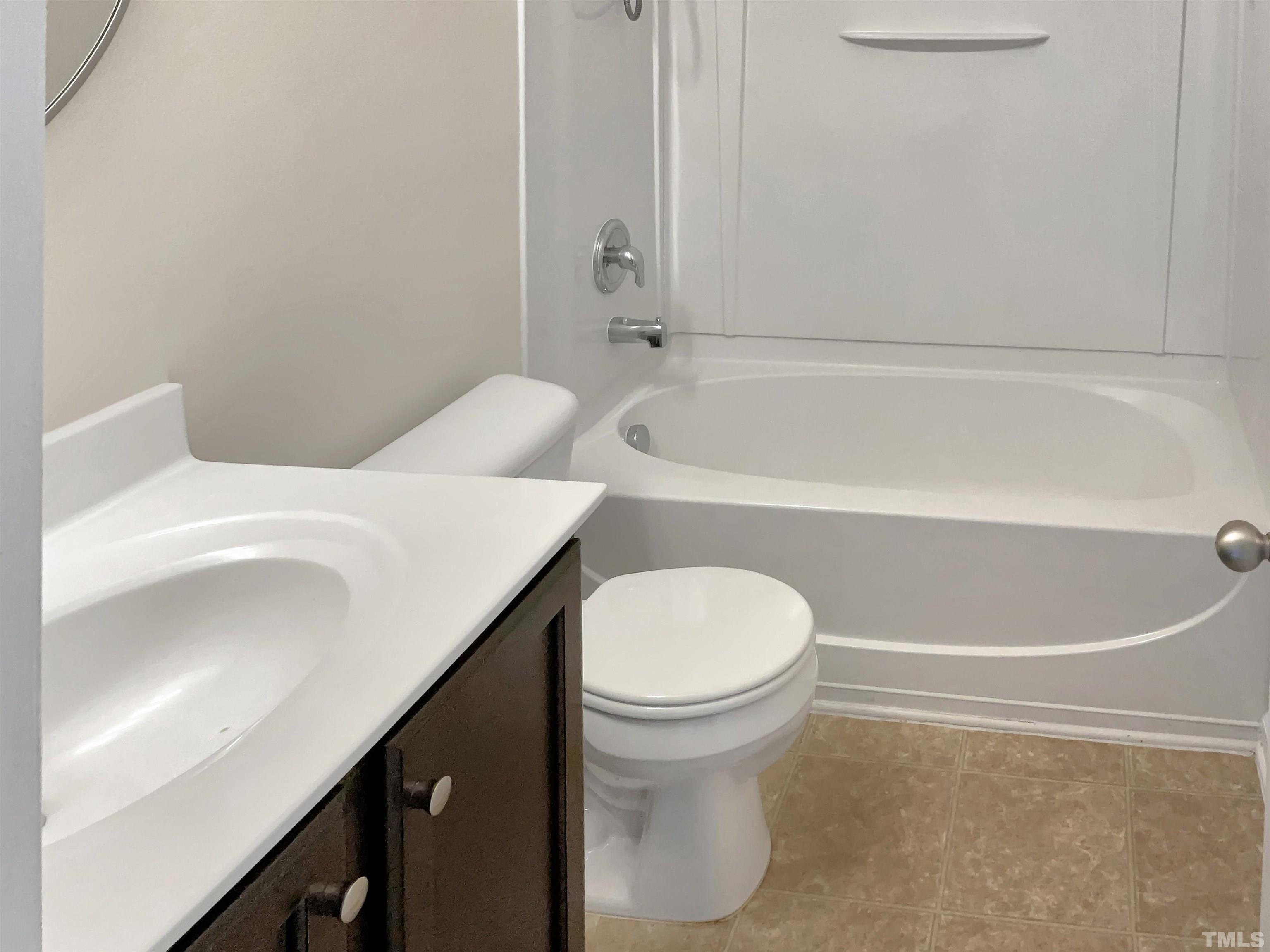 7249 Terregles Drive Raleigh, NC 27617 - Photo 24 of 36 a bathroom with a sink a toilet and bathtub