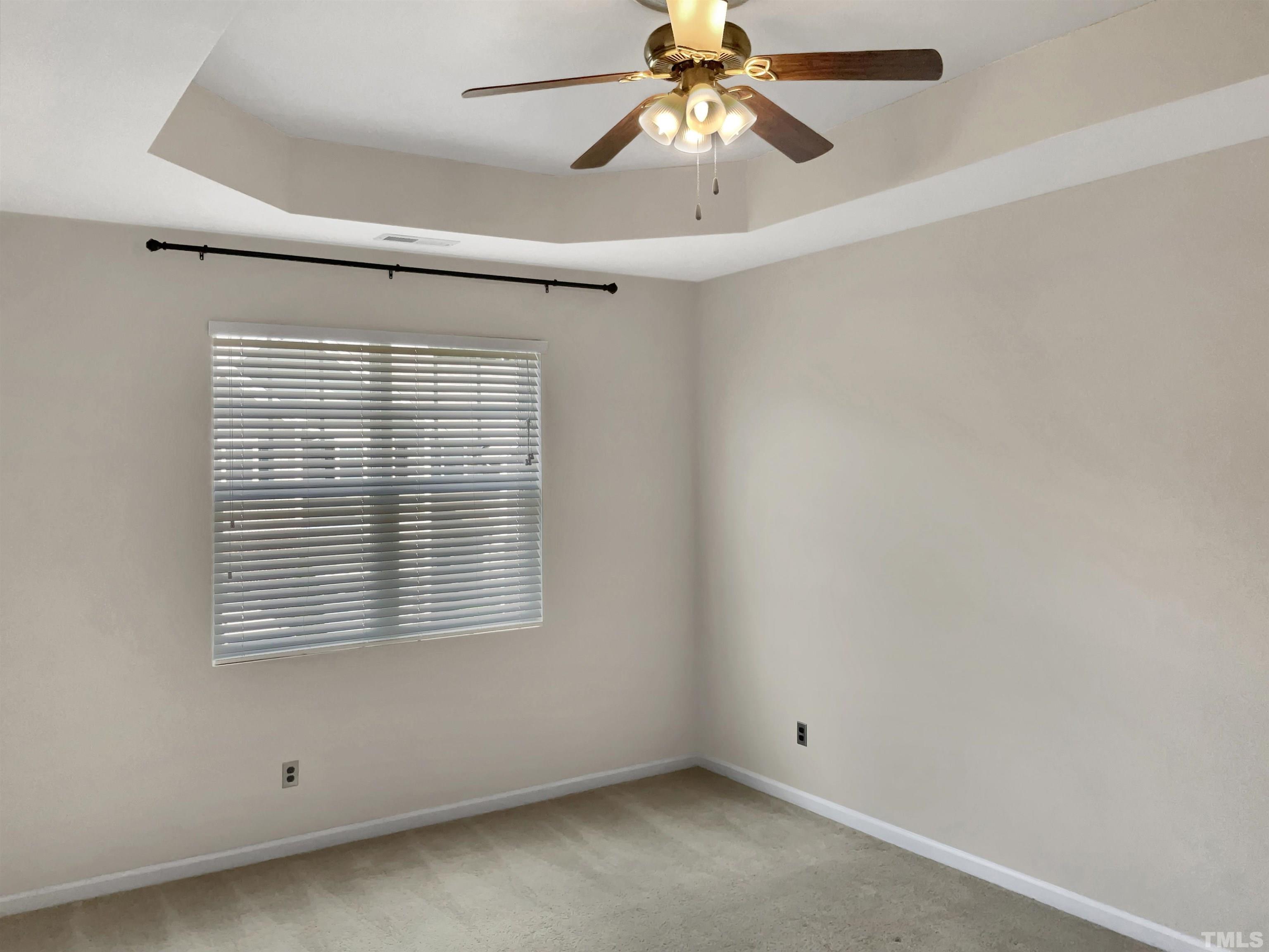 7249 Terregles Drive Raleigh, NC 27617 - Photo 5 of 36 an empty room with a window and a fan