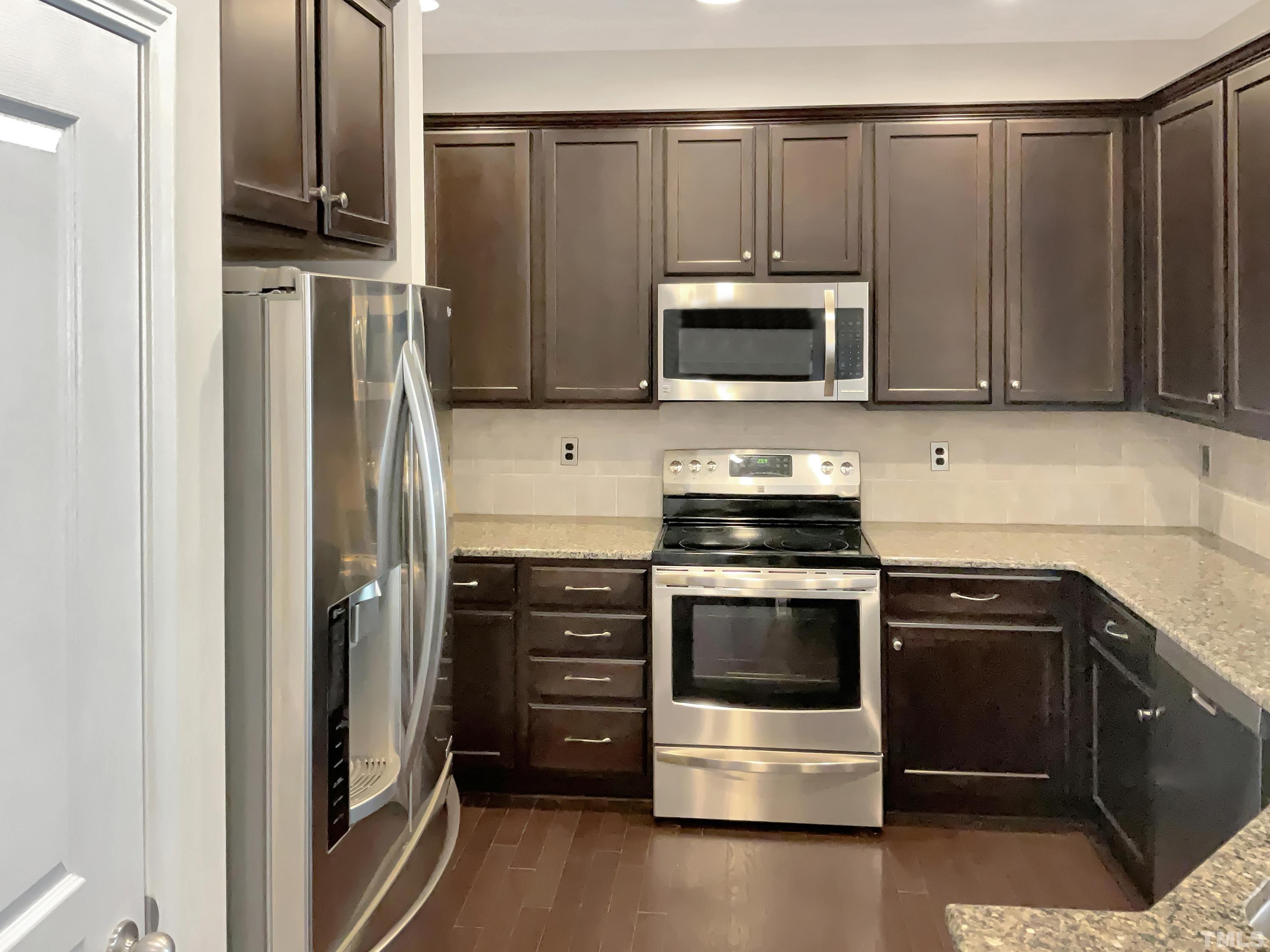 7249 Terregles Drive Raleigh, NC 27617 - Photo 6 of 36 a kitchen with stainless steel appliances and cabinets
