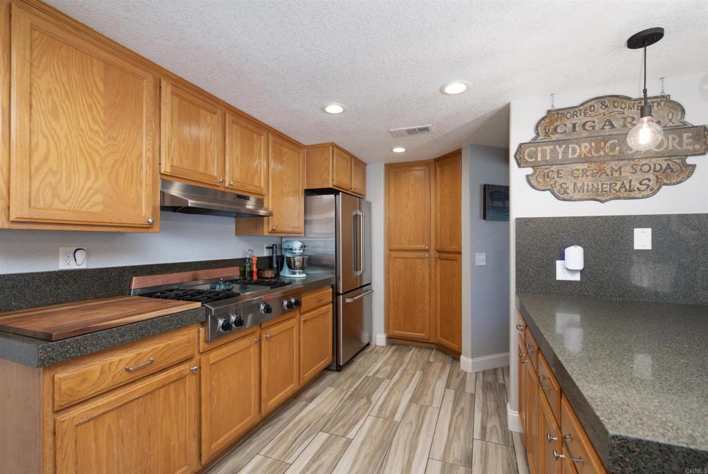 346 Oak Street Ramona, CA 92065 - Photo 16 of 31 a kitchen with stainless steel appliances granite countertop a stove a sink and a refrigerator