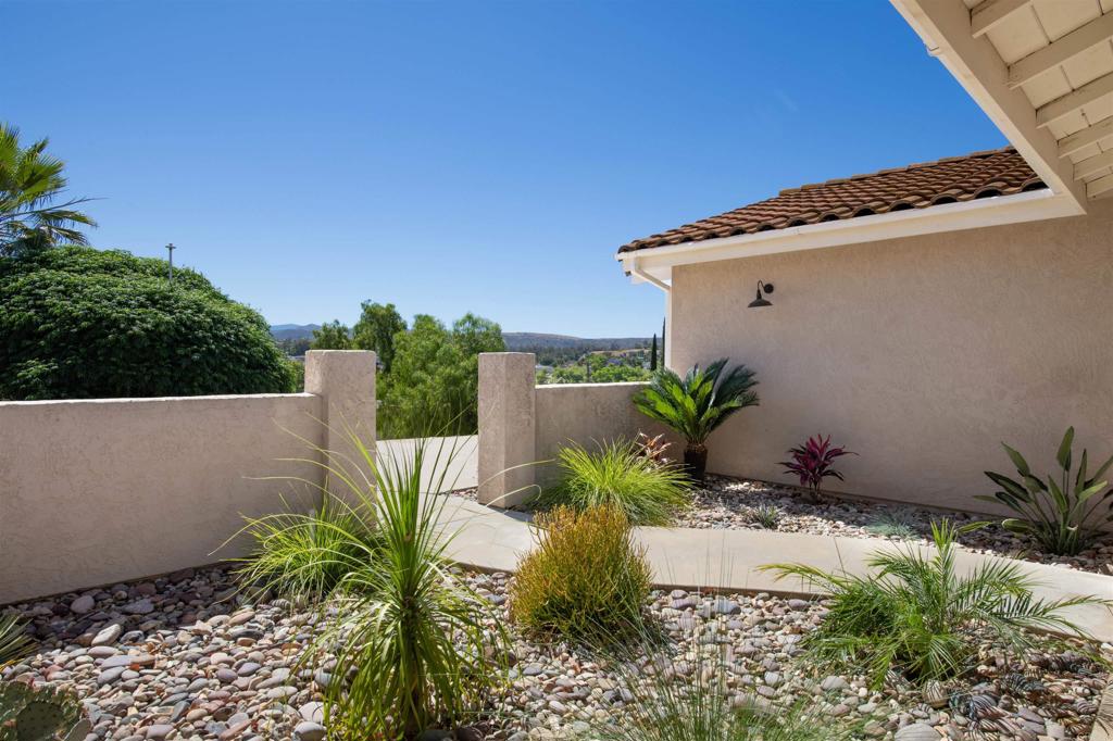 346 Oak Street Ramona, CA 92065 - Photo 2 of 31 a view of a yard with plants and wooden fence