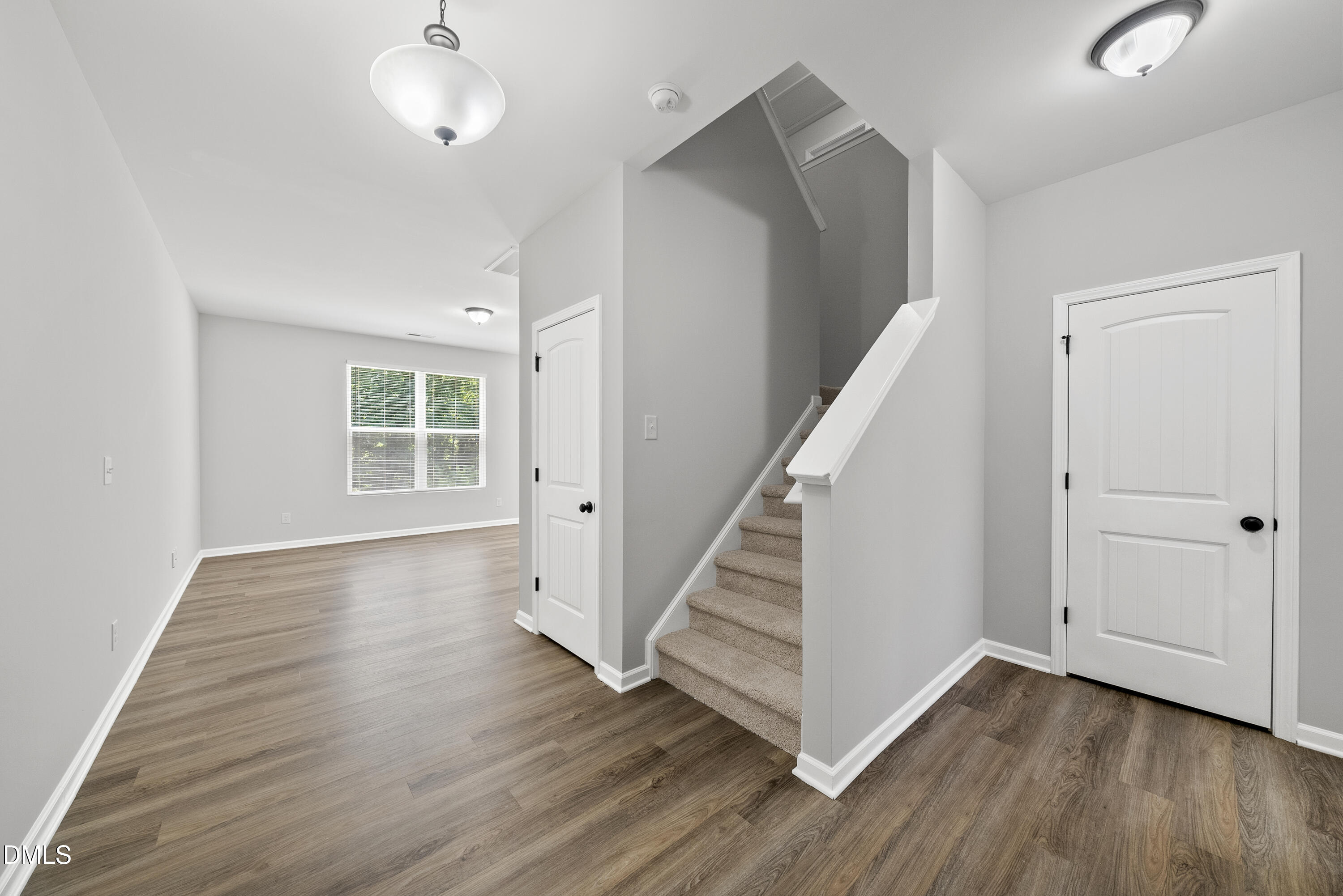 2816 Elsa Drive Raleigh, NC 27610 - Photo 8 of 35 a view of a hallway with wooden floor and stairs