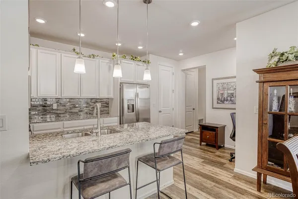 a bathroom with sink and a refrigerator