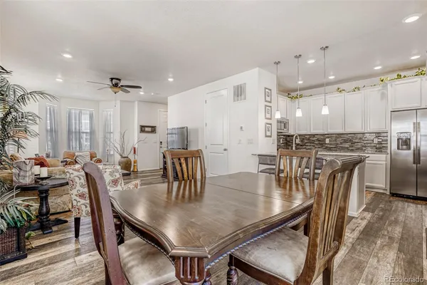 a view of a dining room with furniture and wooden floor