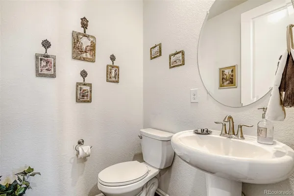 a bathroom with a sink toilet and mirror