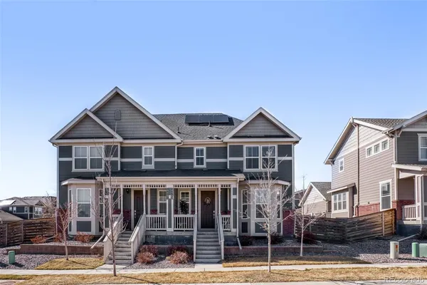 a view of a house with wooden deck and furniture