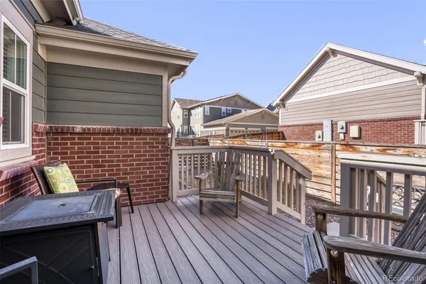a view of a deck with two chairs and a wooden floor