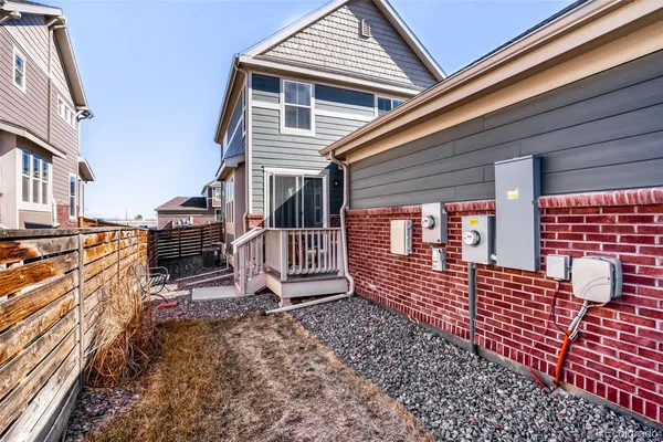 an outdoor view of a house with barbeque