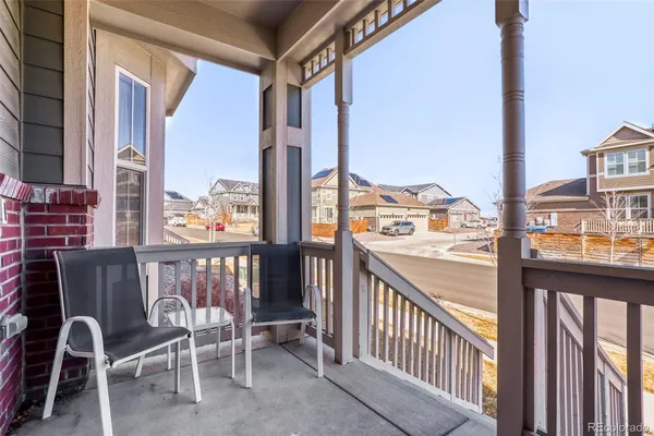 a view of a city from a balcony with furniture