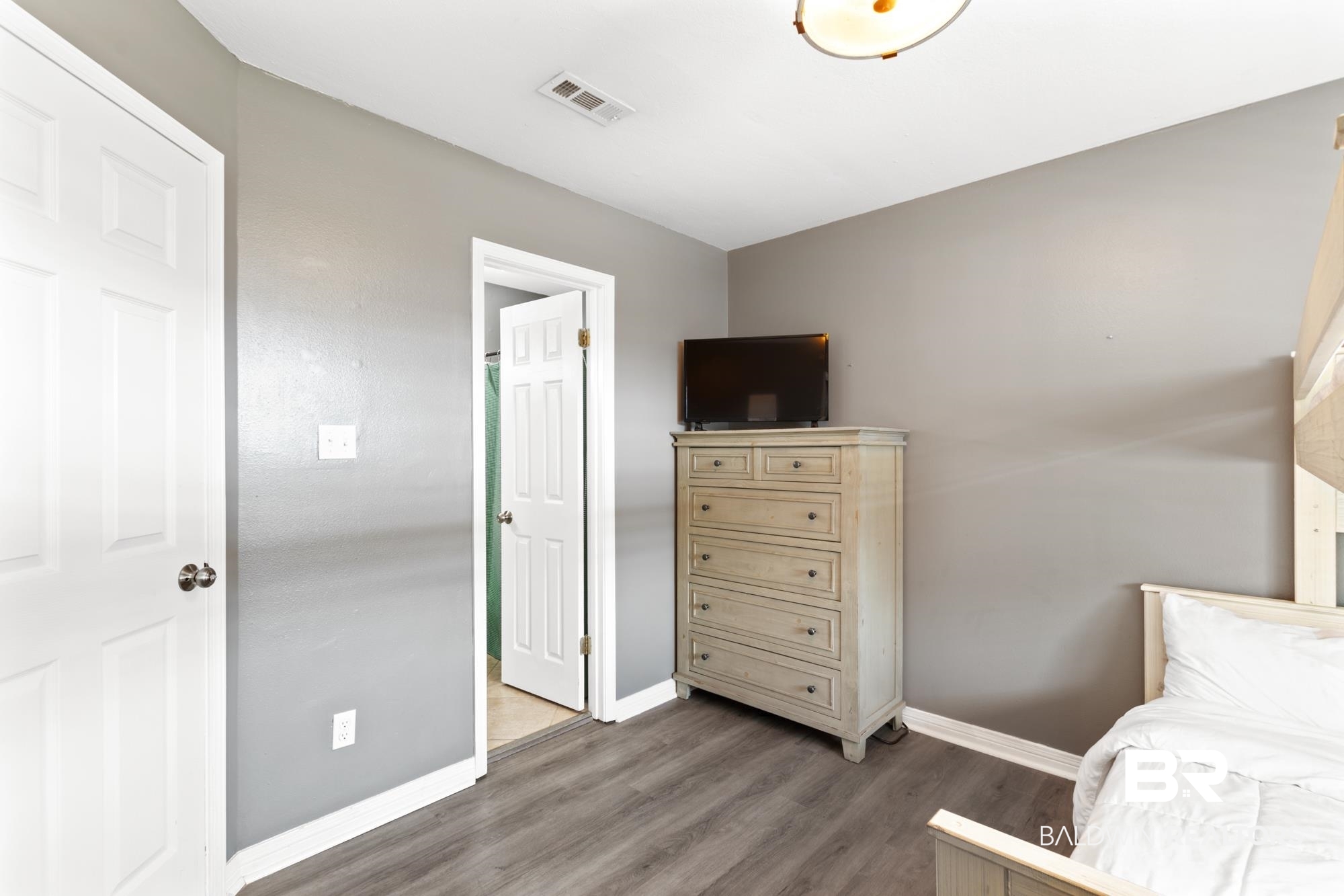 25925 -C Canal Road, Unit 203 Orange Beach, AL 36561 - Photo 22 of 57 Bedroom featuring wood-type flooring