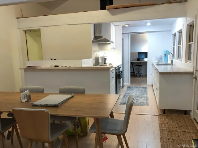 a kitchen with a table chairs sink and cabinets