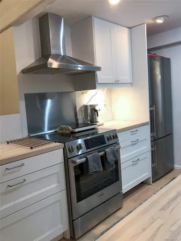 a stove top oven sitting inside of a kitchen