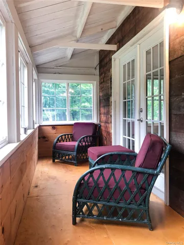 a bedroom with furniture and large windows