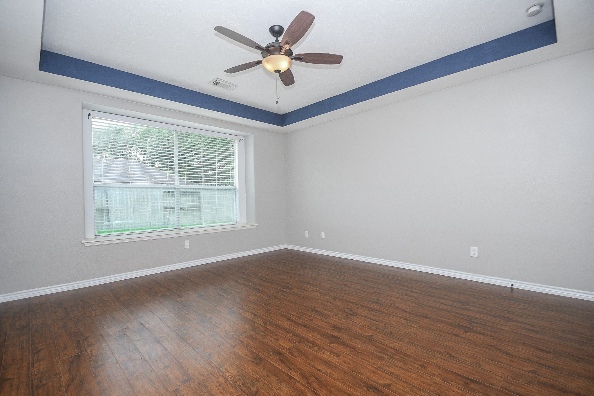 5602 Walkabout Way Katy, TX 77450 - Photo 18 of 33 an empty room with wooden floor and windows