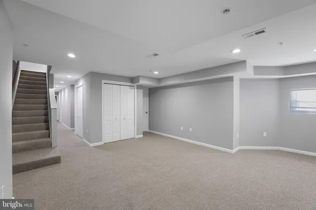 an empty room with a empty space and windows