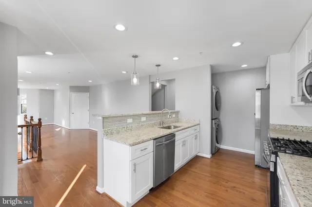 a large kitchen with a large counter top appliances and cabinets