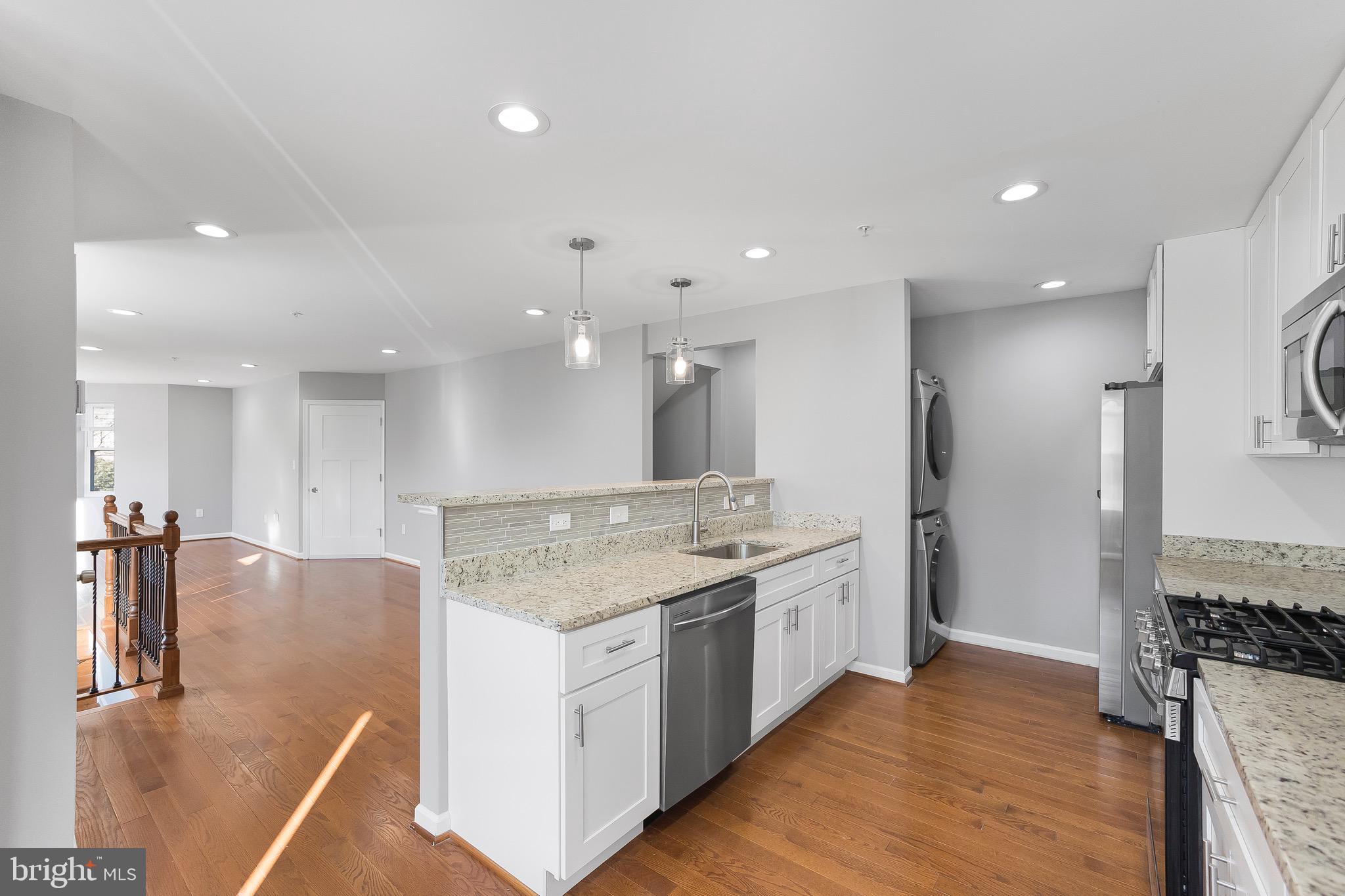 2917 13th Street Northwest Washington, DC 20009 - Photo 8 of 33 a large kitchen with a large counter top appliances and cabinets
