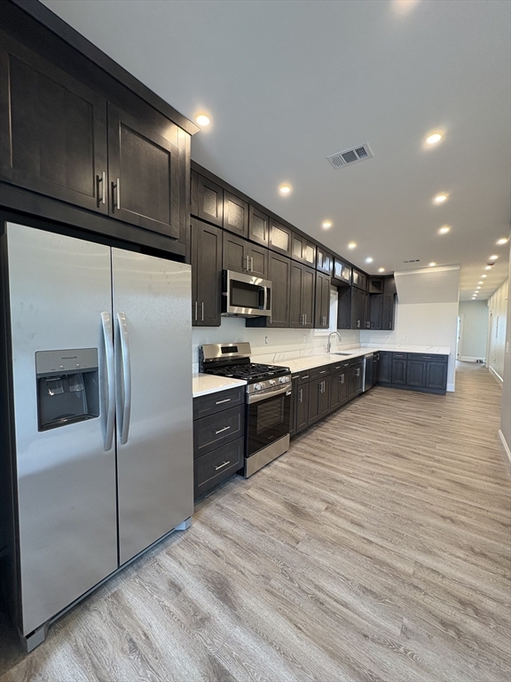 54 Falcon Street, Unit 54 Boston, MA 02128 - Photo 2 of 19 a kitchen with stainless steel appliances kitchen island granite countertop a refrigerator and a stove