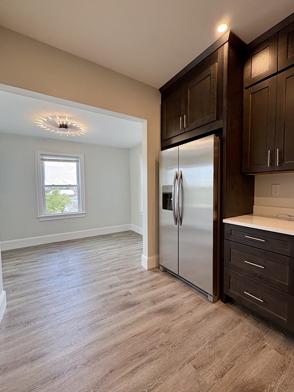 54 Falcon Street, Unit 54 Boston, MA 02128 - Photo 3 of 19 a kitchen with granite countertop stainless steel appliances a refrigerator and microwave