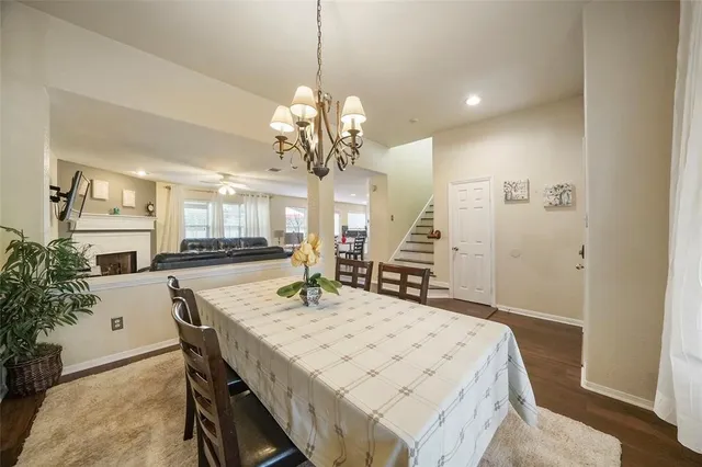 a view of a dining room with furniture and a chandelier