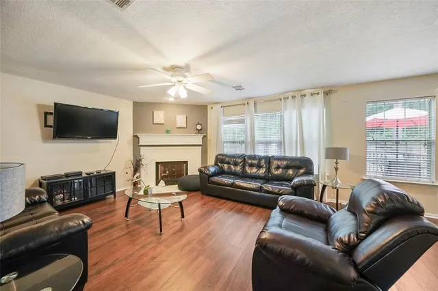 a living room with fireplace furniture and a flat screen tv
