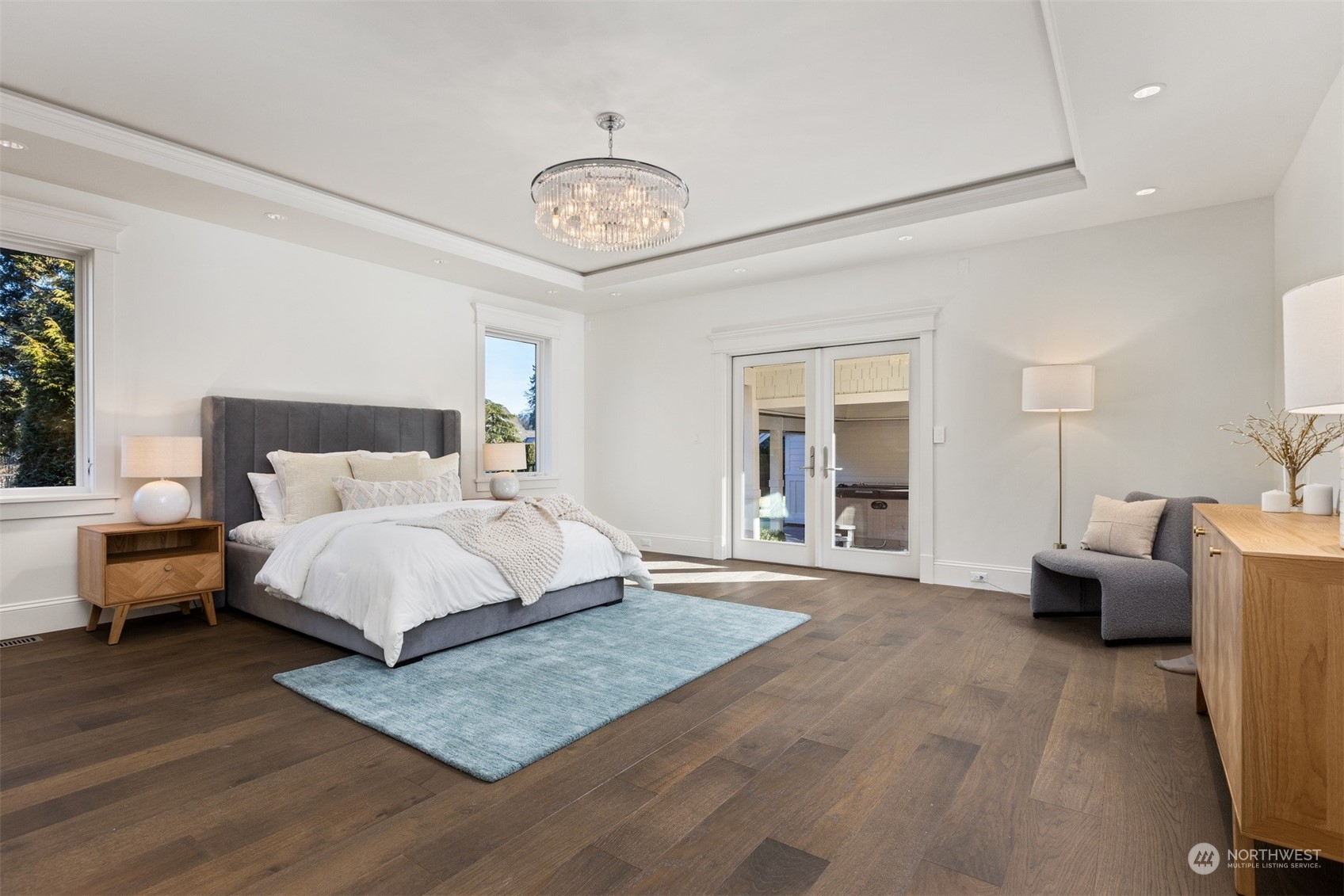 627 Linden Road Bellingham, WA 98225 - Photo 19 of 40 a bedroom with a large bed and a chandelier