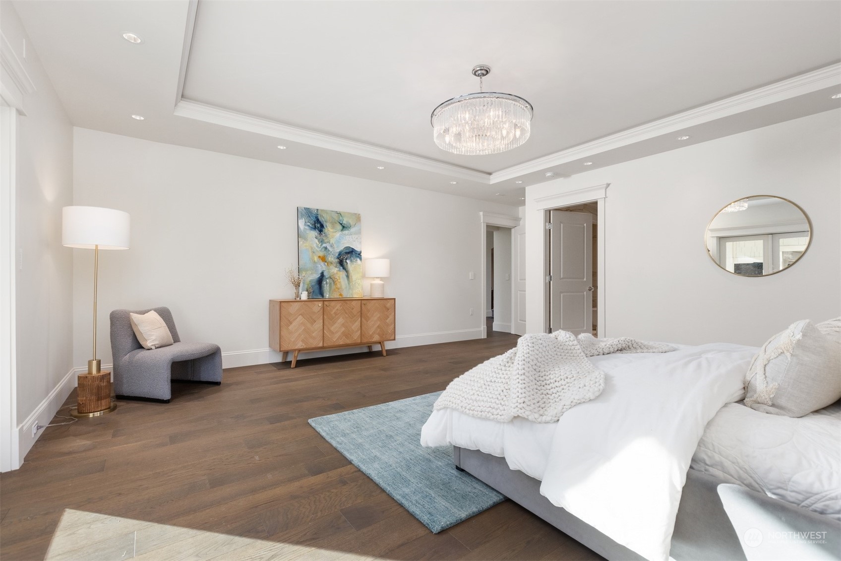 627 Linden Road Bellingham, WA 98225 - Photo 20 of 40 a spacious bedroom with a bed and a chandelier