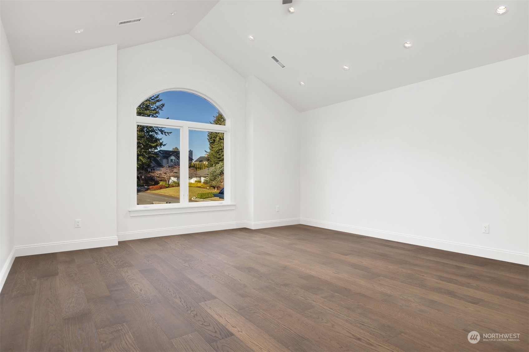 627 Linden Road Bellingham, WA 98225 - Photo 26 of 40 an empty room with wooden floor and windows