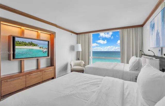 a bedroom with a bed and a flat screen tv