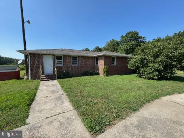 a view of house that has a yard