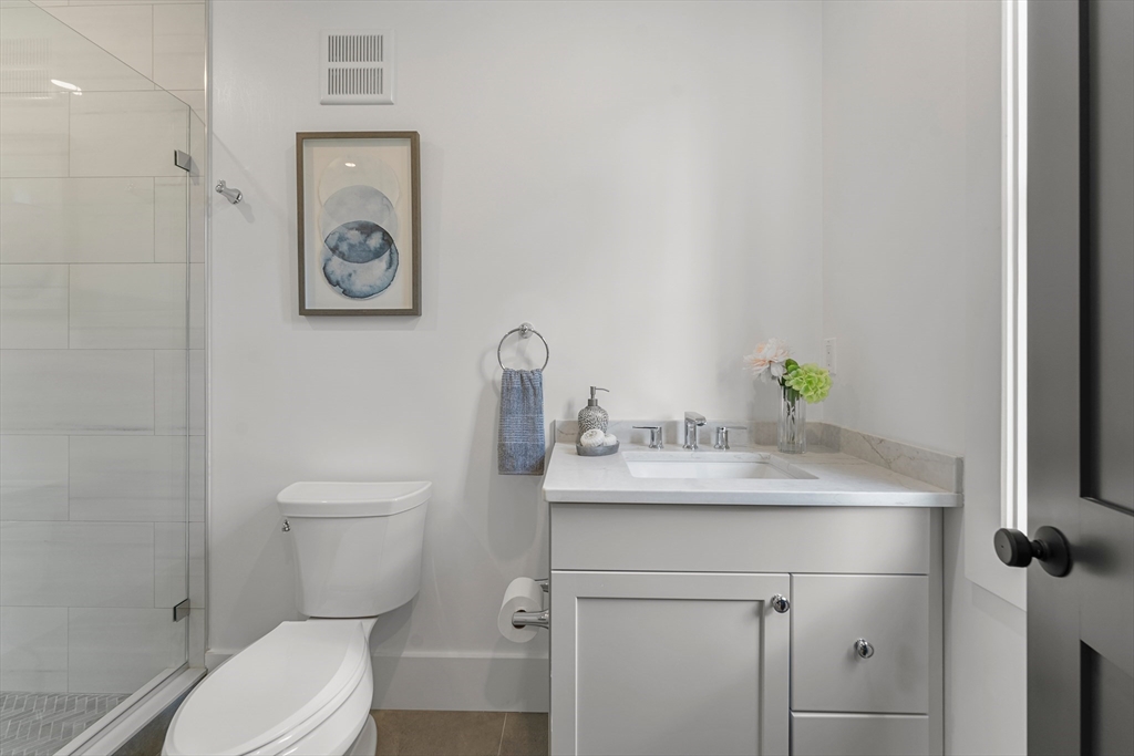12 Guild Road, Unit 12 Needham, MA 02494 - Photo 15 of 32 a bathroom with a toilet sink and mirror