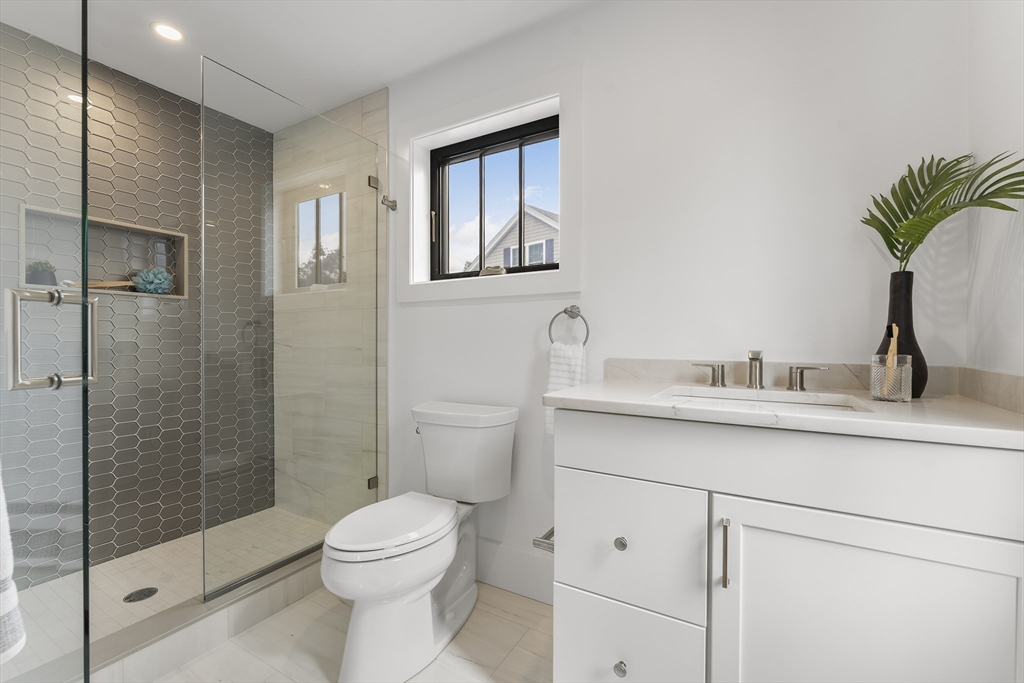 12 Guild Road, Unit 12 Needham, MA 02494 - Photo 21 of 32 a bathroom with a sink a toilet and shower