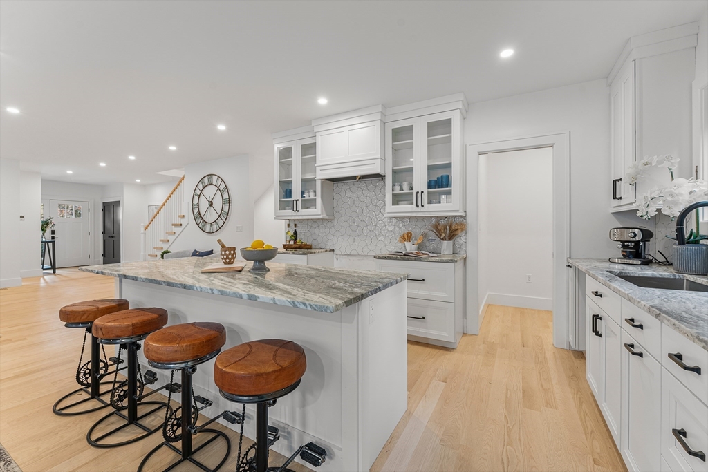 12 Guild Road, Unit 12 Needham, MA 02494 - Photo 10 of 32 a kitchen with stainless steel appliances granite countertop a sink and a refrigerator