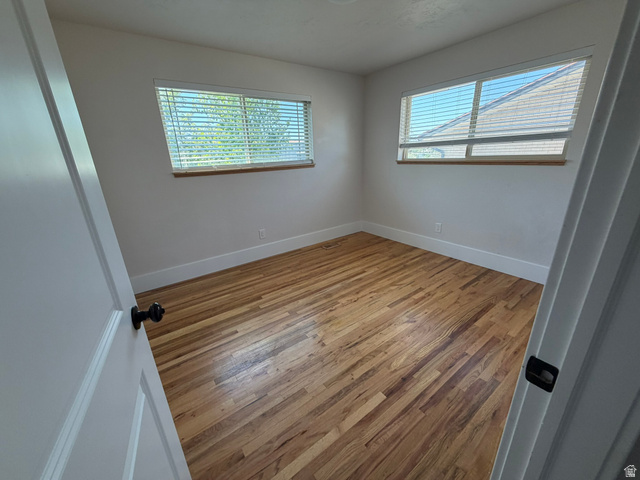 541 Mingo View Avenue Sandy, UT 84070 - Photo 4 of 16 Room featuring wood-finish flooring, white baseboards, and neutral wall paint