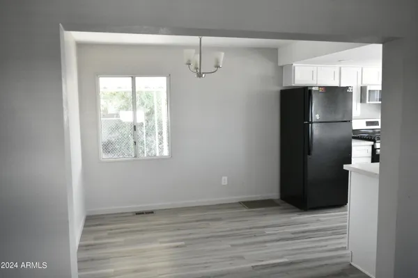 a kitchen with a refrigerator and a stove top oven