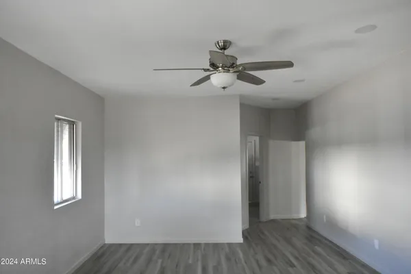 a kitchen with stainless steel appliances granite countertop a refrigerator a sink a stove and wooden floors