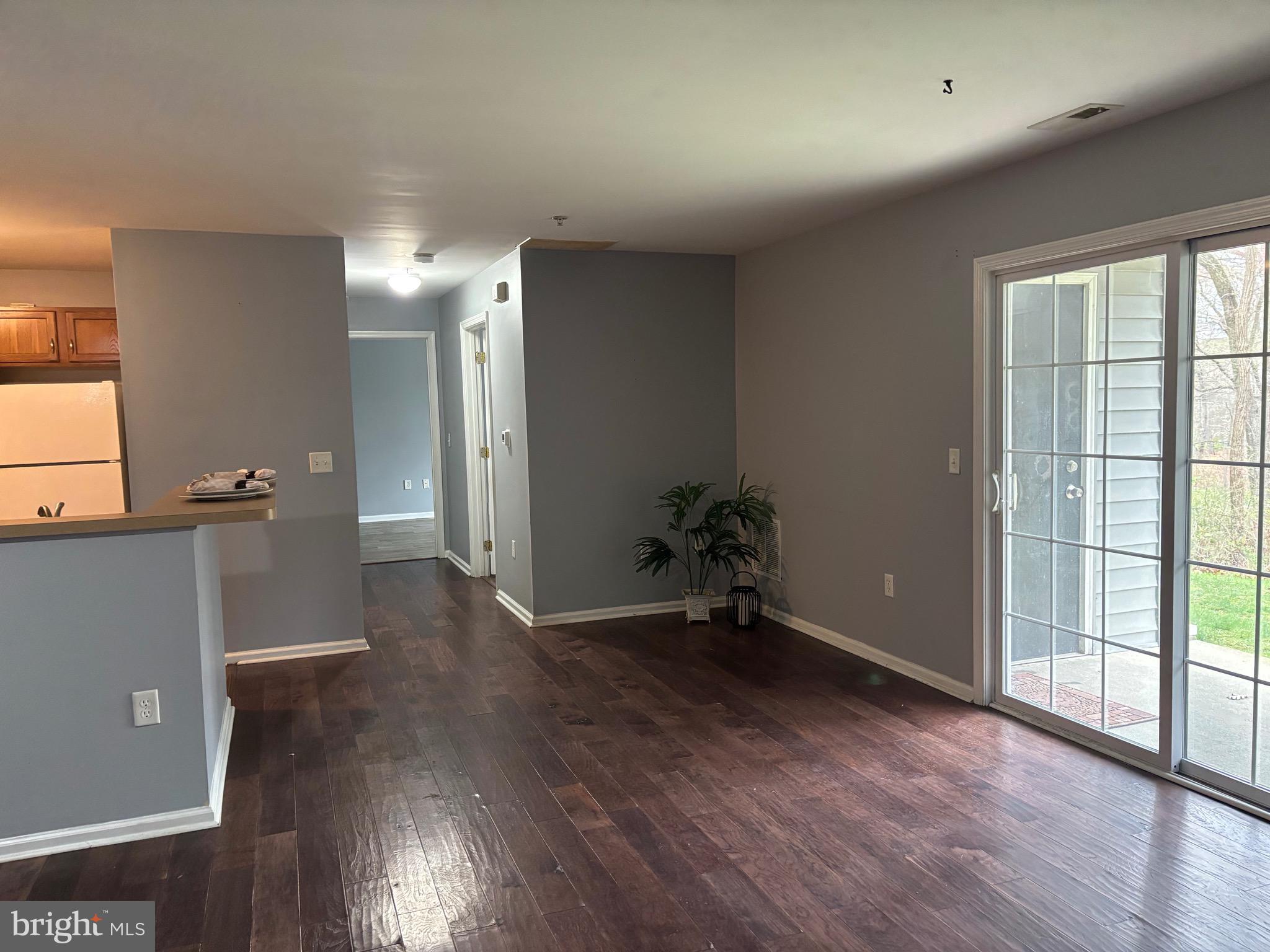 127 Natalie Road Riverside, NJ 08075 - Photo 5 of 18 an empty room with wooden floor and windows