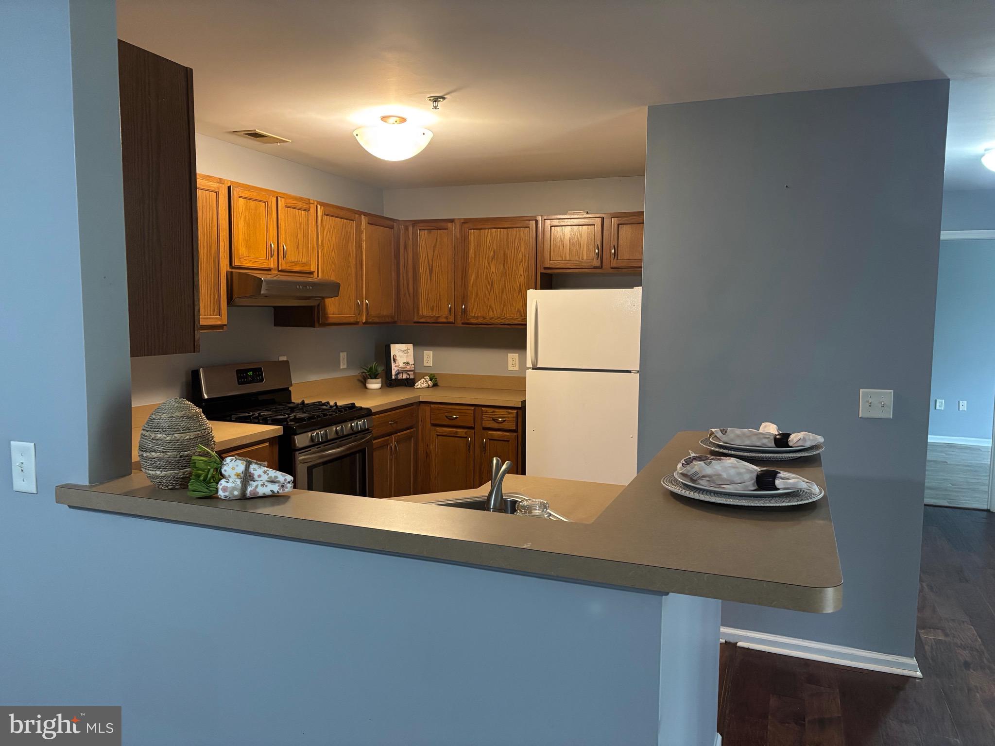 127 Natalie Road Riverside, NJ 08075 - Photo 6 of 18 a kitchen with a sink a refrigerator and a stove