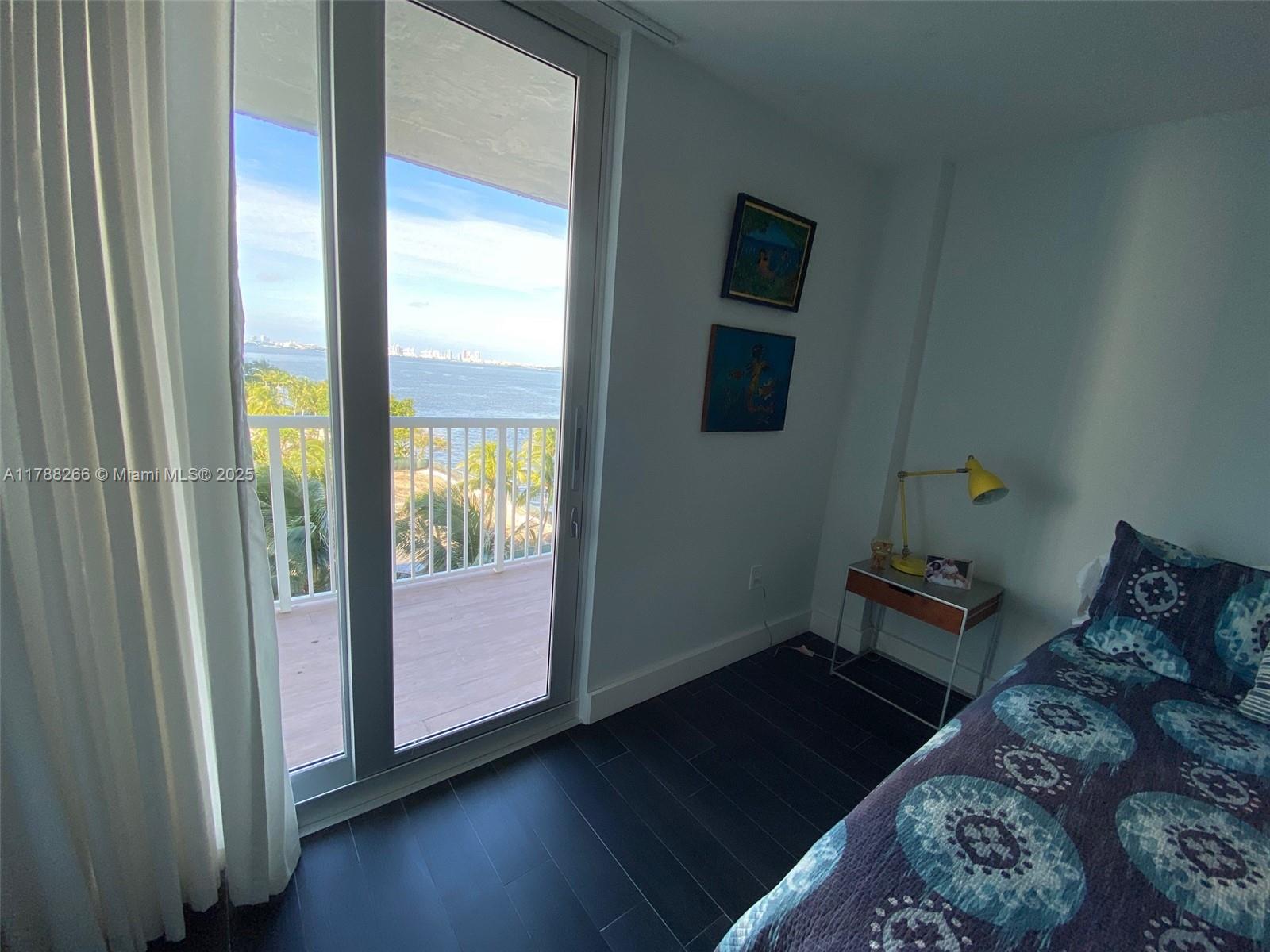 150 Southeast 25th Road, Unit 7A Miami, FL 33129 - Photo 12 of 18 a bedroom with a bed and wooden floor