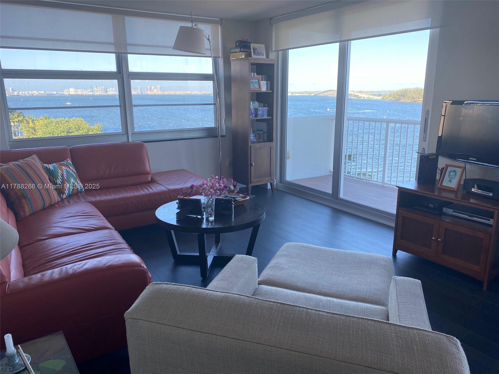 150 Southeast 25th Road, Unit 7A Miami, FL 33129 - Photo 4 of 18 a living room with furniture and a flat screen tv