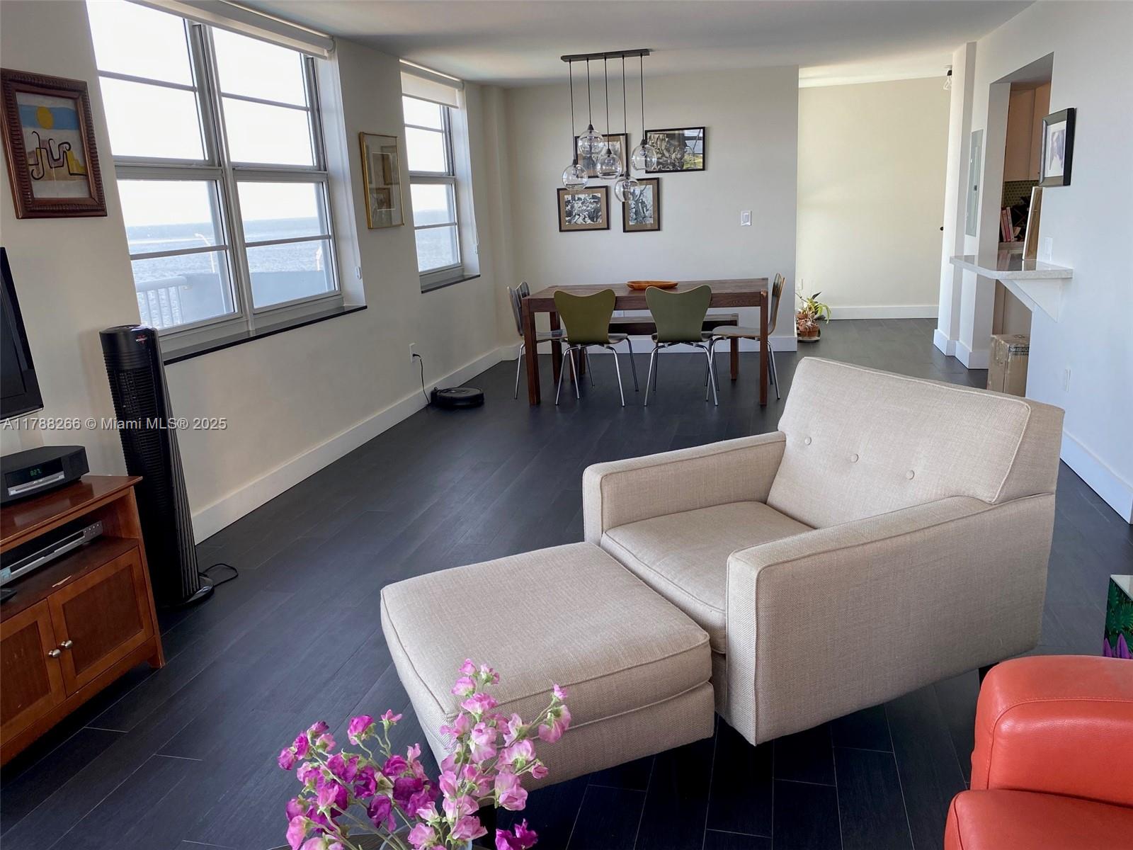 150 Southeast 25th Road, Unit 7A Miami, FL 33129 - Photo 5 of 18 a living room with furniture a flat screen tv and a window