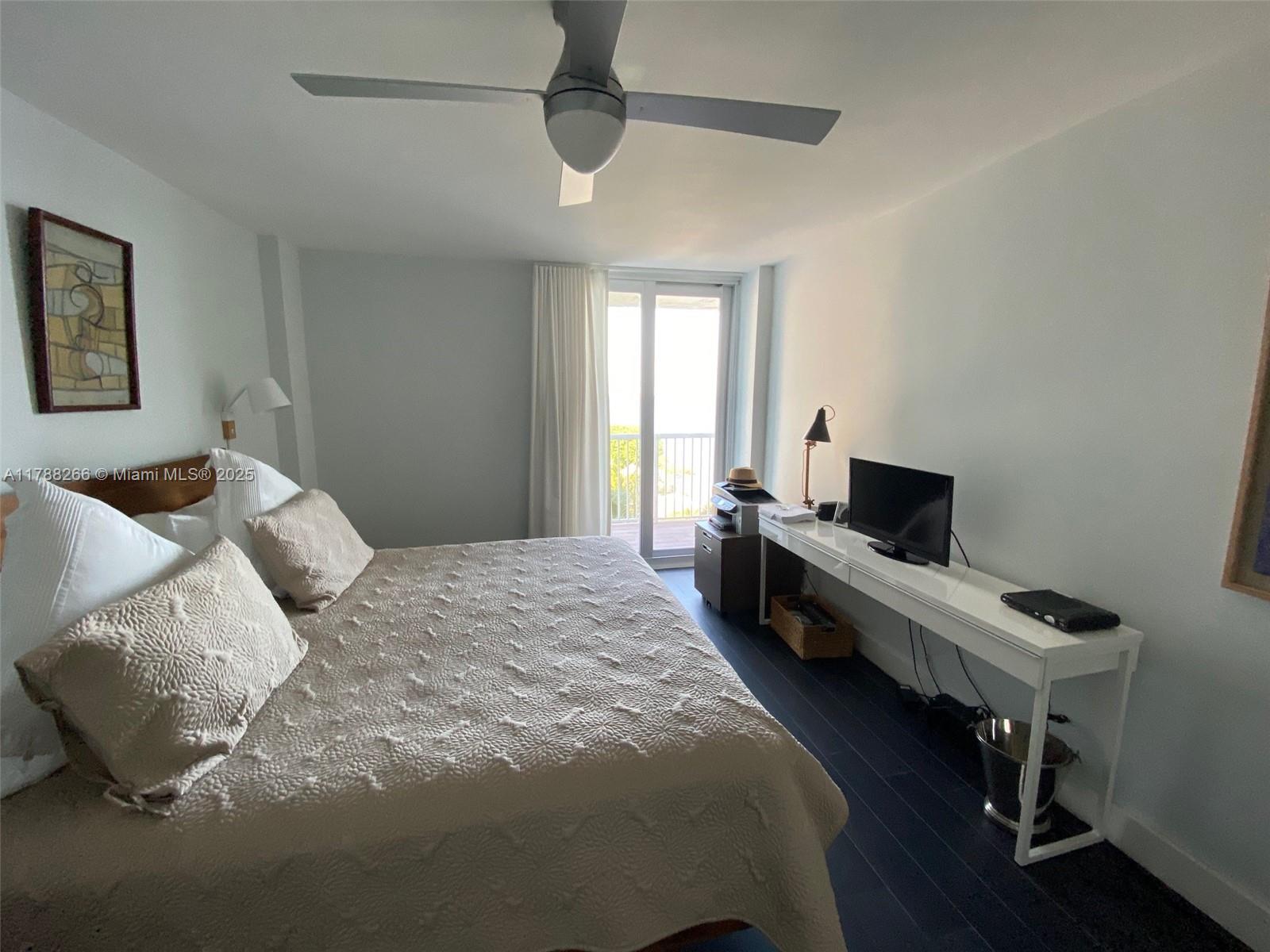 150 Southeast 25th Road, Unit 7A Miami, FL 33129 - Photo 9 of 18 a bedroom with a bed and a desk