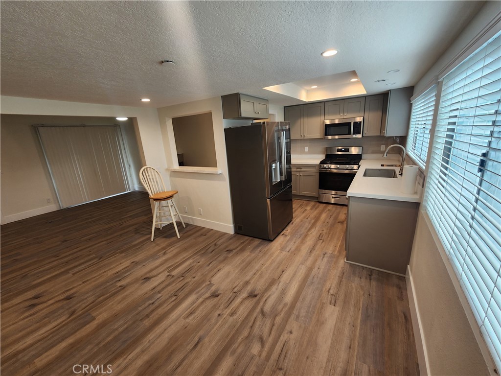 418 Avenida Santa Barbara, Unit B San Clemente, CA 92672 - Photo 11 of 52 a kitchen with stainless steel appliances granite countertop a refrigerator a stove top oven a sink and dishwasher