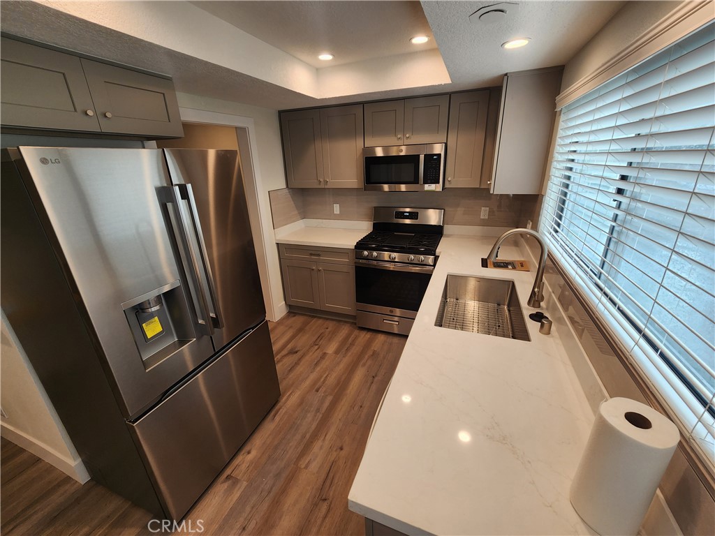 418 Avenida Santa Barbara, Unit B San Clemente, CA 92672 - Photo 12 of 52 a kitchen with wooden cabinets and a stainless steel appliances