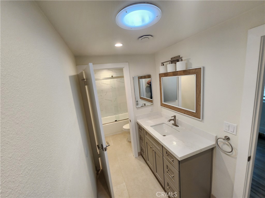 418 Avenida Santa Barbara, Unit B San Clemente, CA 92672 - Photo 26 of 52 a bathroom with a sink a mirror and a toilet