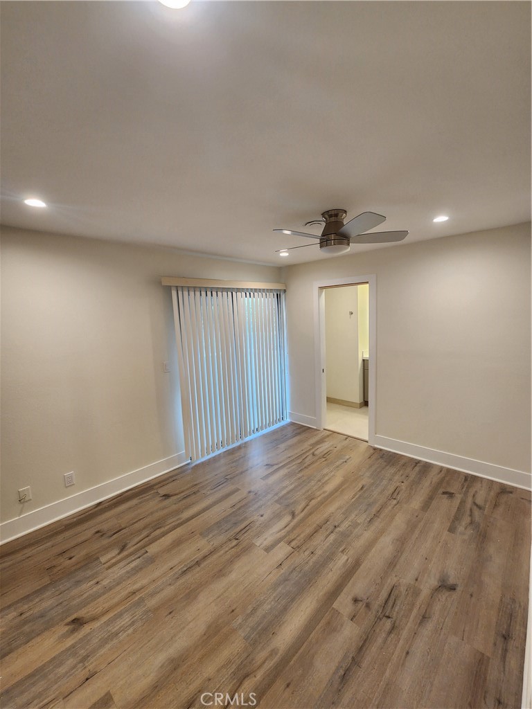 418 Avenida Santa Barbara, Unit B San Clemente, CA 92672 - Photo 32 of 52 a view of an empty room with wooden floor and a window