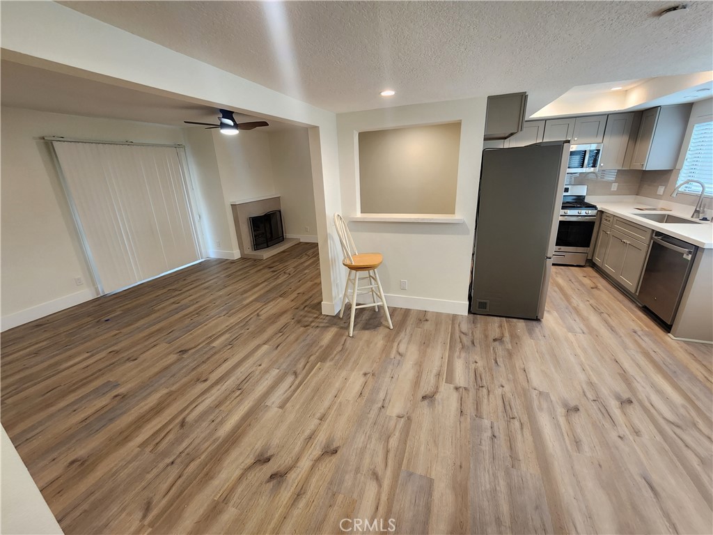 418 Avenida Santa Barbara, Unit B San Clemente, CA 92672 - Photo 7 of 52 a view of kitchen with refrigerator microwave and wooden floor